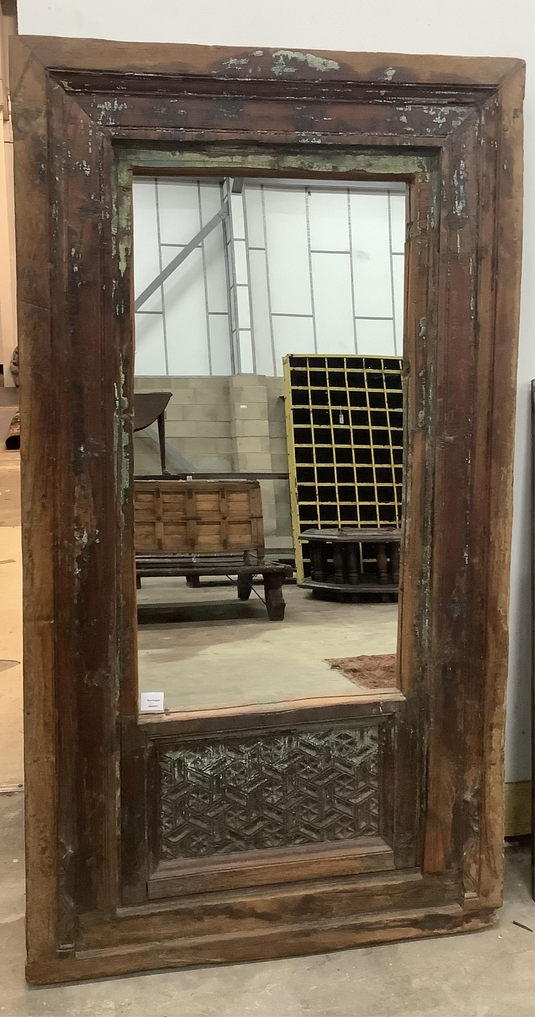 An Indian rectangular carved hardwood wall mirror, width 88cm, height 160cm and a smaller rectangular pine wall mirror (2). Condition - fair